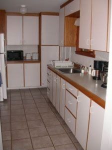 Galley kitchen with new appliances.